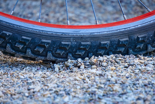 Close-up of a bicycle tire and rim on a gravel surface