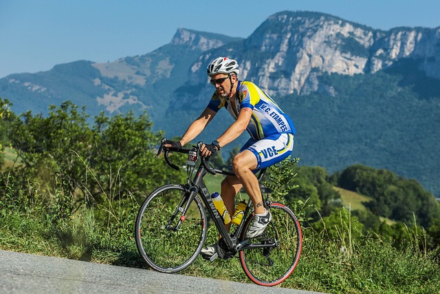 Mountain biker taking a sip from a durable cycling water bottle mounted on their frame.