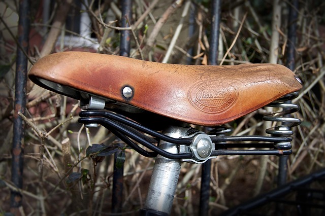 A vintage leather bicycle saddle mounted on a seatpost