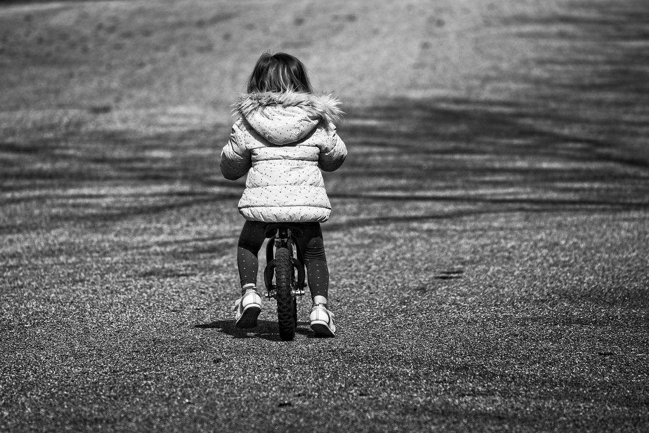child on balance bike