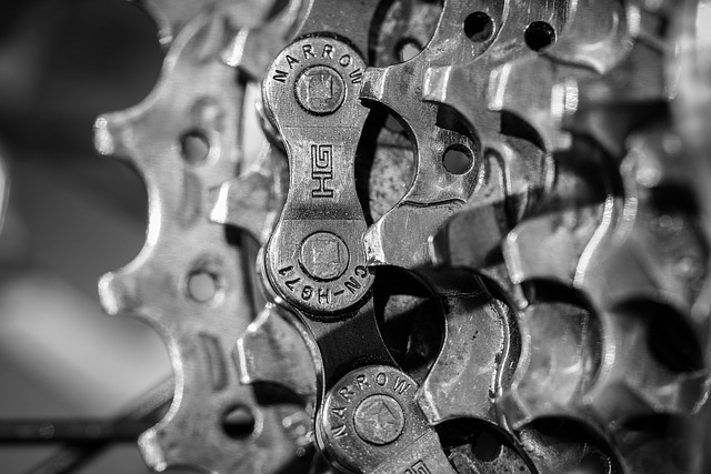close-up of a bike chain with lube being applied to each roller