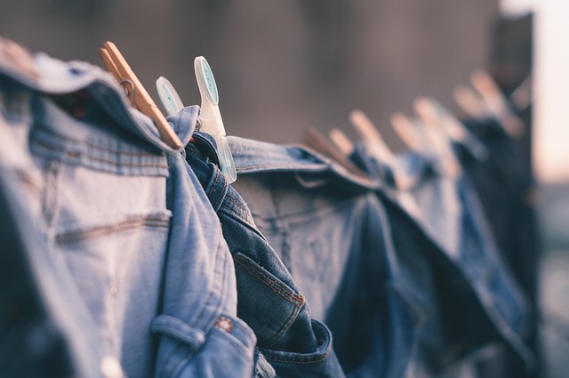 Denim jeans hanging on a clothesline with clothespins