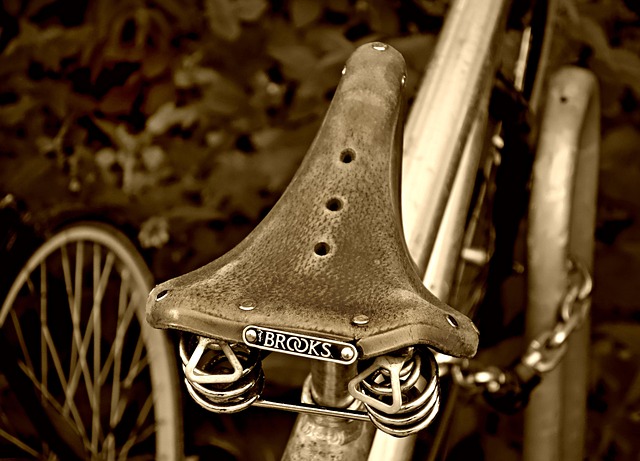 A close-up of a vintage Brooks leather bicycle saddle