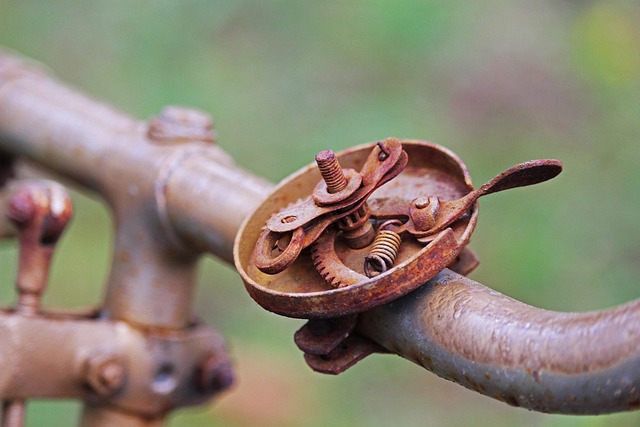 Internal rusted mechanism of an old bicycle bell on handlebars
