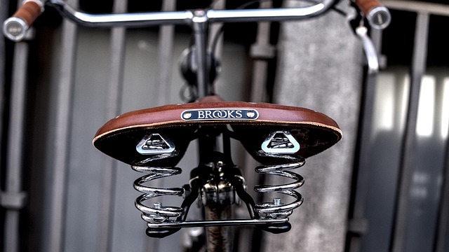 A vintage leather bicycle saddle with metal springs