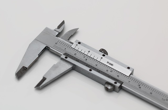 A metallic vernier caliper on a plain surface